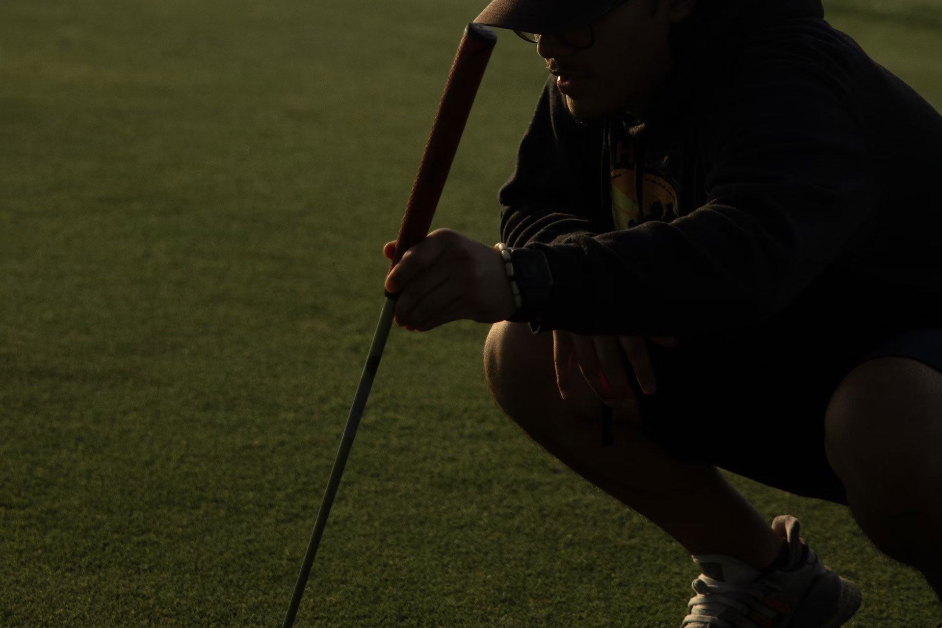 A man crouching contemplating his next shot