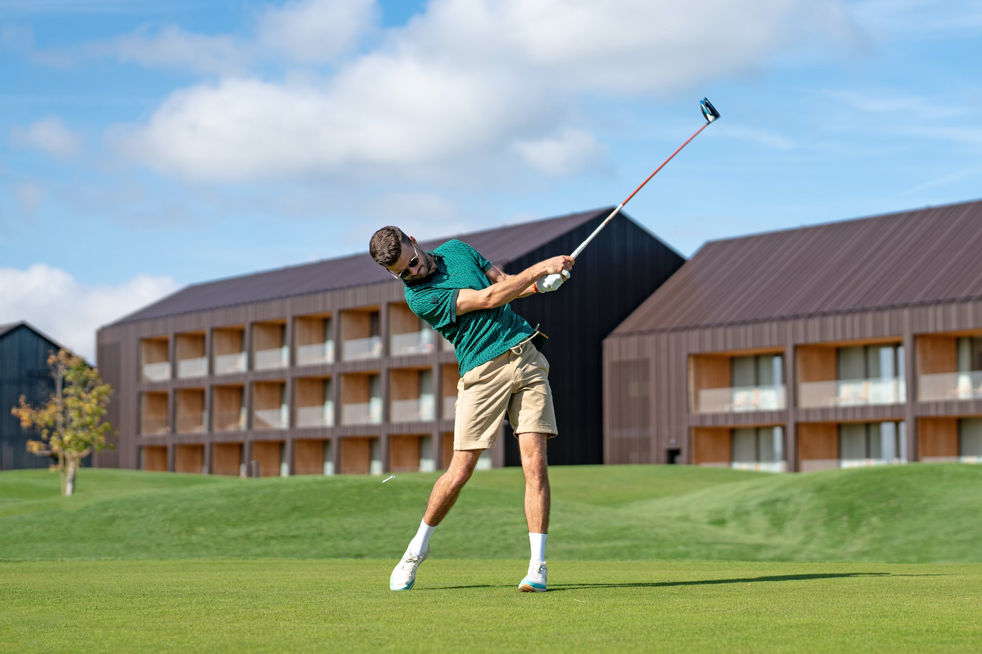 A man taking a shot during a round of golf