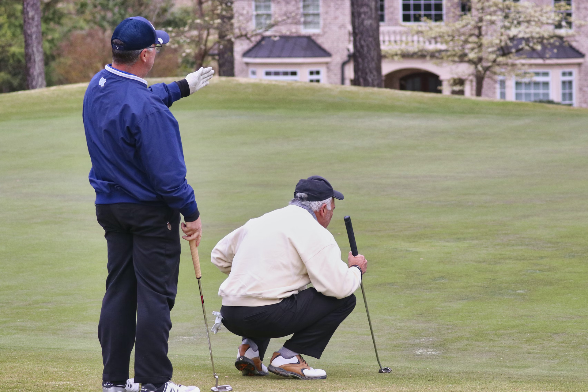 An elderly pair of golfers assessing a tricky shot