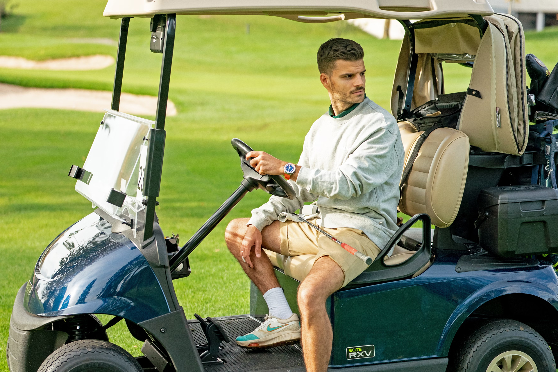 A man sitting in a golf cart