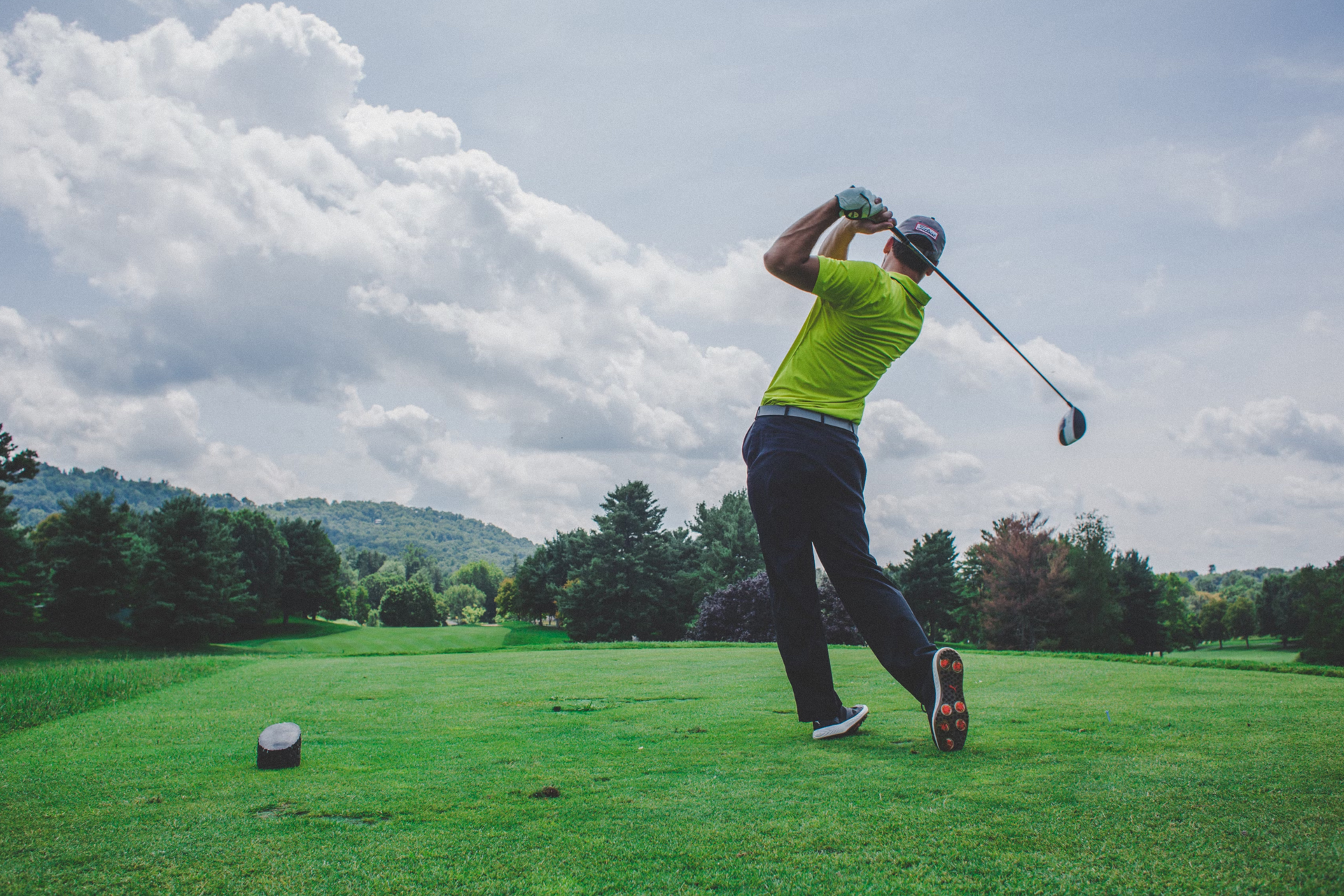 A man taking his first shot during a golf round