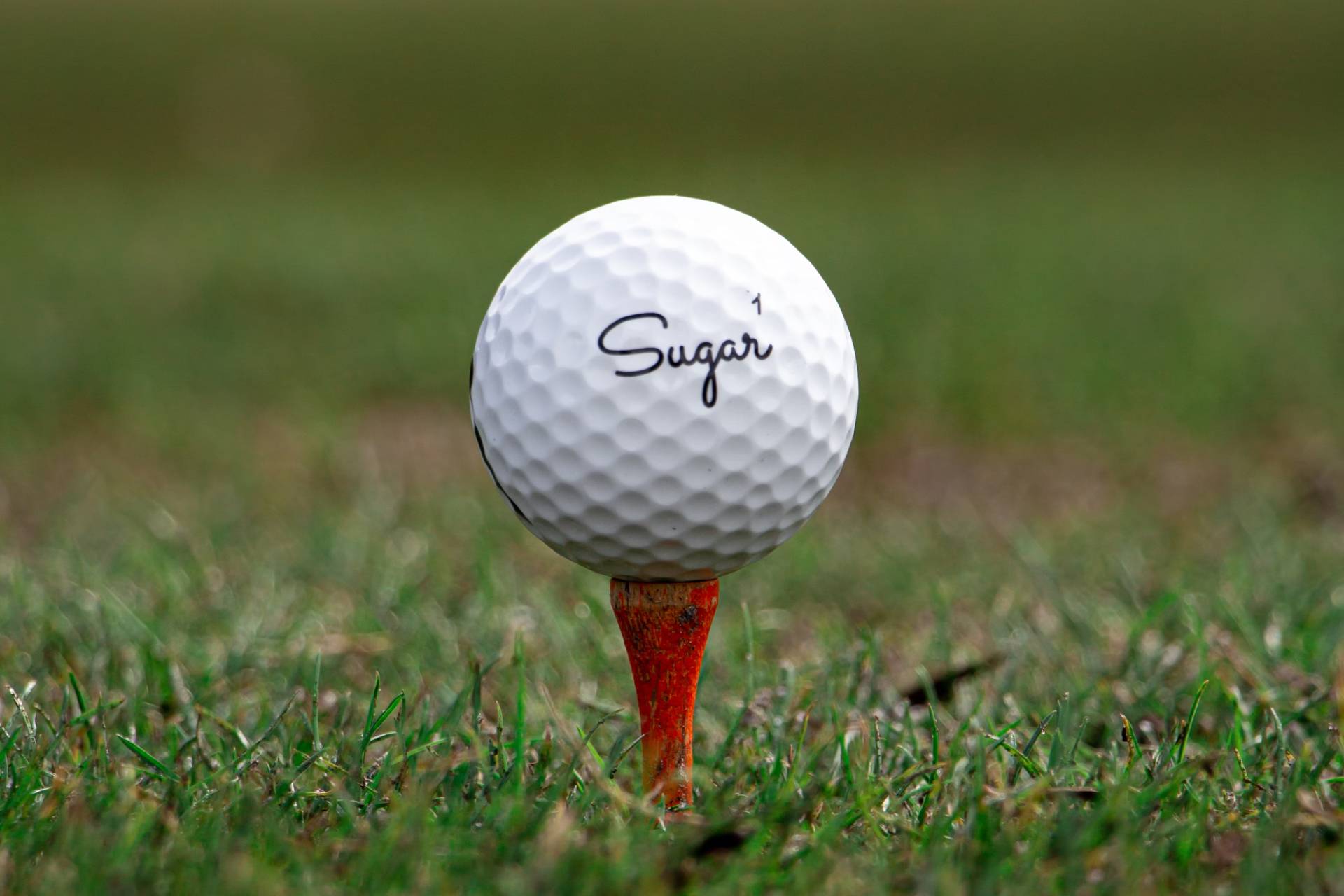 A white Sugar branded golf ball