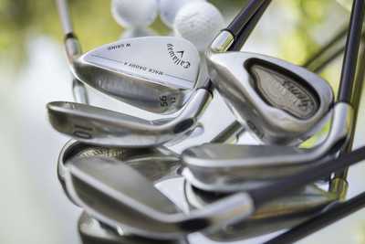 Golf balls and golf clubs on a table