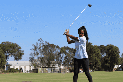 A young female golfer about to take a big shot