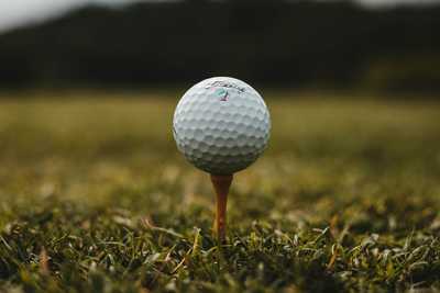 A golf ball sat on a golf tee