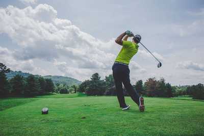 A man having just driven a tee shot