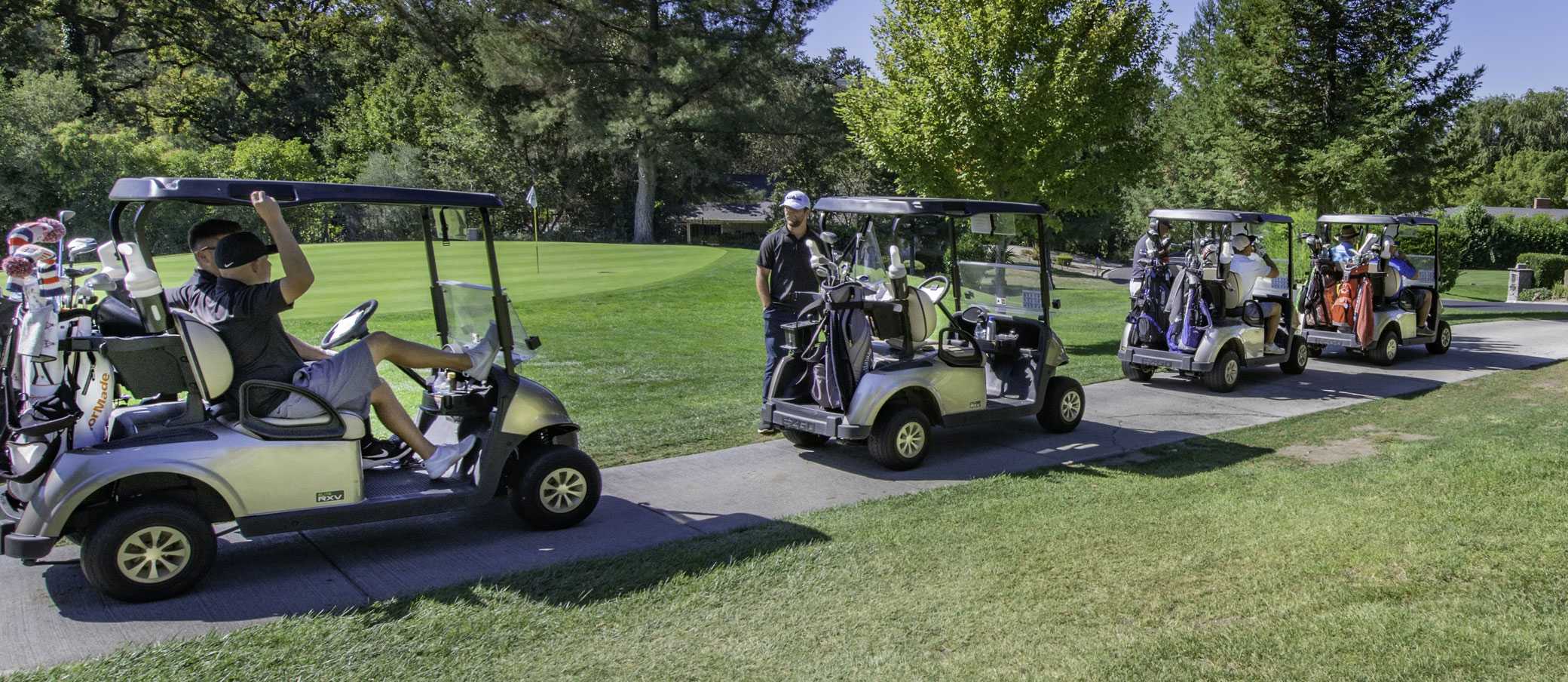 Golfers in golf carts travelling to their next hole.