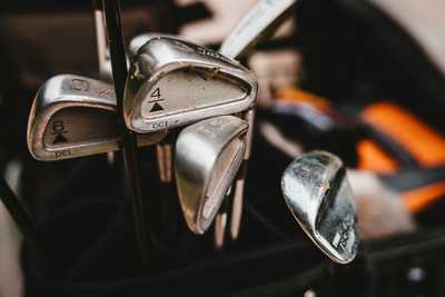 Gold clubs in a golf bag