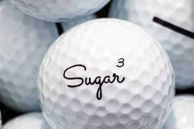 A white Sugar branded golf ball